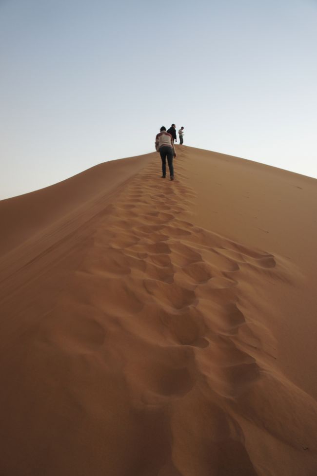 climbing sand dunes in the sahara