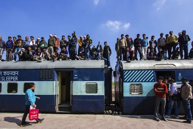 people standing on a train in India