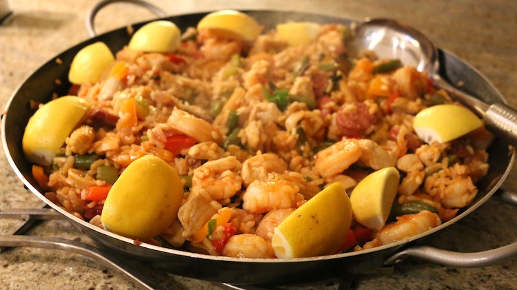 Paella served with lemon wedges