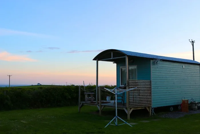 Shepherd huts at sunset in Swansea Bay