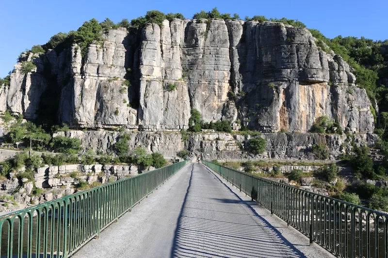 Walking over the bridge in Balazuc