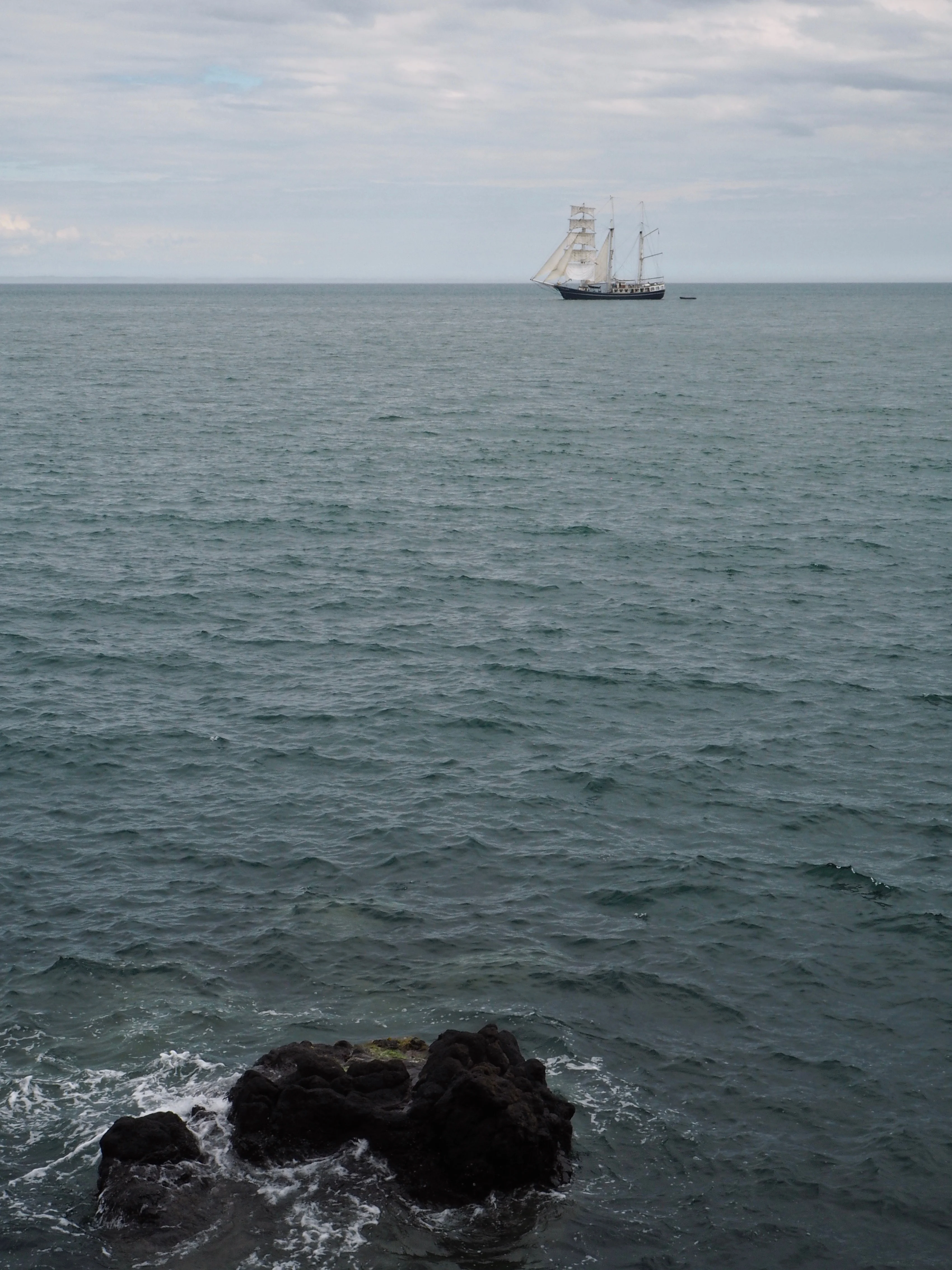 Sailing ship on the horizon with rocks in foreground - Beyond the City Break in Belfast with Flybe and Avis