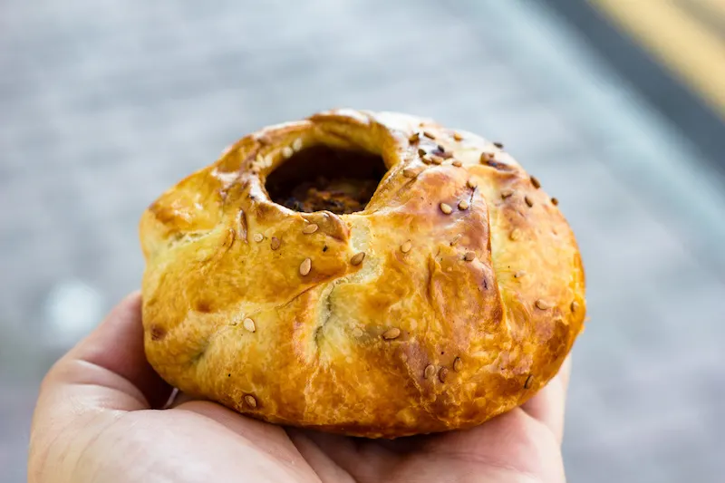 Traditional Maltese street food. Anchovy and olive pie.