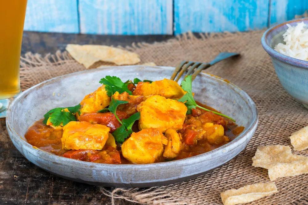 Fish Mappas - Kerala style coconut fish curry with rice. It's a popular dish in southern Indian state of Kerala.