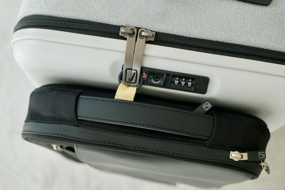 Laptop magnet in front of suitcase